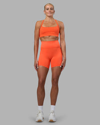 Woman wearing Momentum Sports Bra - Ultra Orange | Model:Katie | Size:S