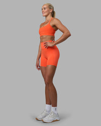 Woman wearing Momentum Sports Bra - Ultra Orange | Model:Katie | Size:S
