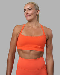 Woman wearing Momentum Sports Bra - Ultra Orange | Model:Katie | Size:S