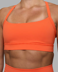 Woman wearing Momentum Sports Bra - Ultra Orange | Model:Katie | Size:S
