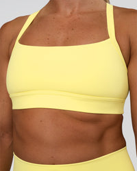 Woman wearing Momentum Sports Bra - Yellow Fizz | Model:Sav | Size:S