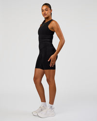 Woman wearing NyxRun Stash Tank - Black | Model:Rosie | Size:S