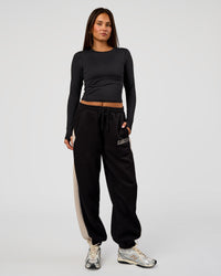 Woman wearing Power Play Stitch Up Fleece Sweat Pant - Black-Shale Beige | Model:Bianca | Size:S