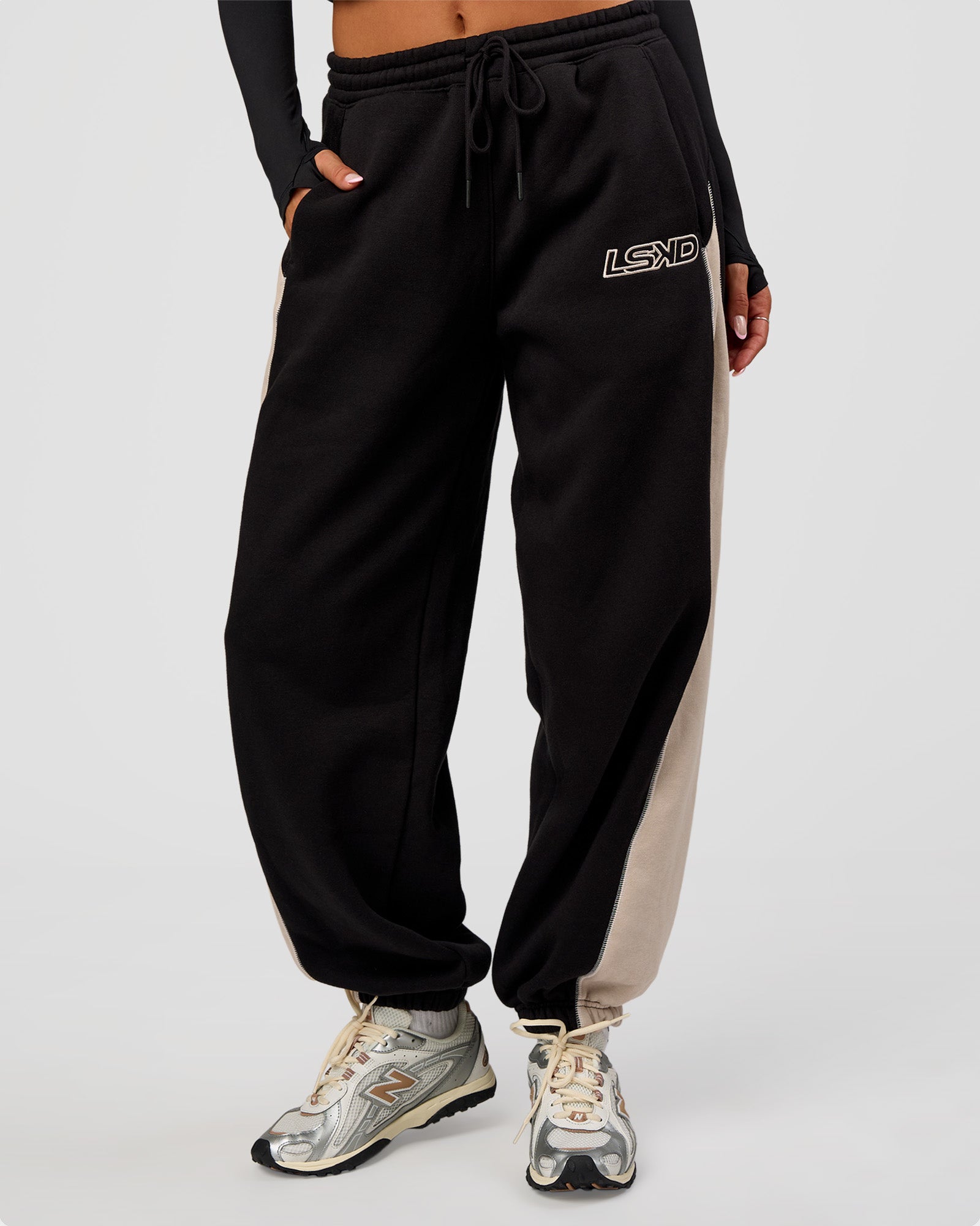 Woman wearing Power Play Stitch Up Fleece Sweat Pant - Black-Shale Beige | Model:Bianca | Size:S