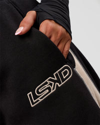 Woman wearing Power Play Stitch Up Fleece Sweat Pant - Black-Shale Beige | Model:Bianca | Size:S