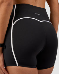 Woman wearing Power Ultra High-Rise 4" Short Pockets - Black | Model:Rhiley | Size:S