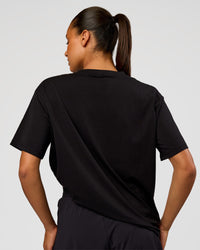 Woman wearing Pride Go-To FLXCotton Oversized Tee - Black | Model:Rosie | Size:S