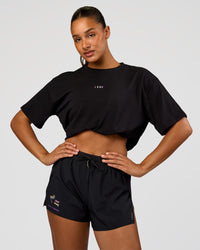 Woman wearing Pride Go-To FLXCotton Oversized Tee - Black | Model:Rosie | Size:S