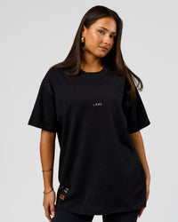 Woman wearing Pride Sticker Boxy Tee - Black | Model:Bianca | Size:S