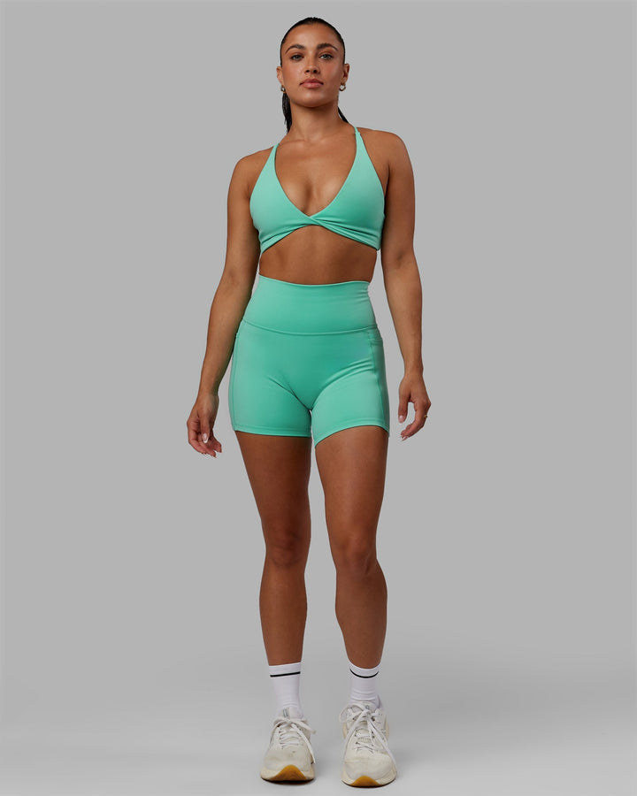 Woman wearing Progression Sports Bra - Aquatic Awe
