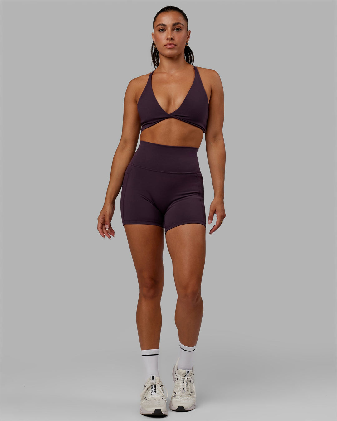 Woman wearing Progression Sports Bra - Midnight Plum