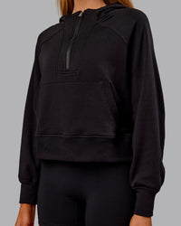 Woman wearing Pursue Mid-Weight Hoodie - Black | Model:Ella | Size:S