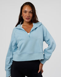 Woman wearing Pursue Mid-Weight Hoodie - Glacial Blue | Model:Kirstyn | Size:S