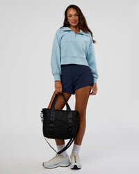 Woman wearing Pursue Mid-Weight Hoodie - Glacial Blue | Model:Kirstyn | Size:S