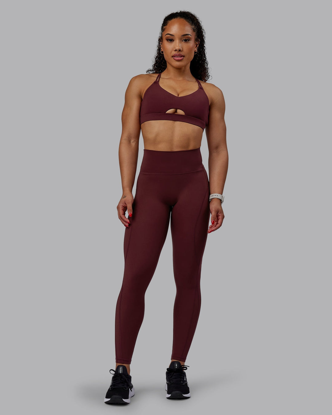 Woman wearing Pursue Sports Bra - Dark Cherry