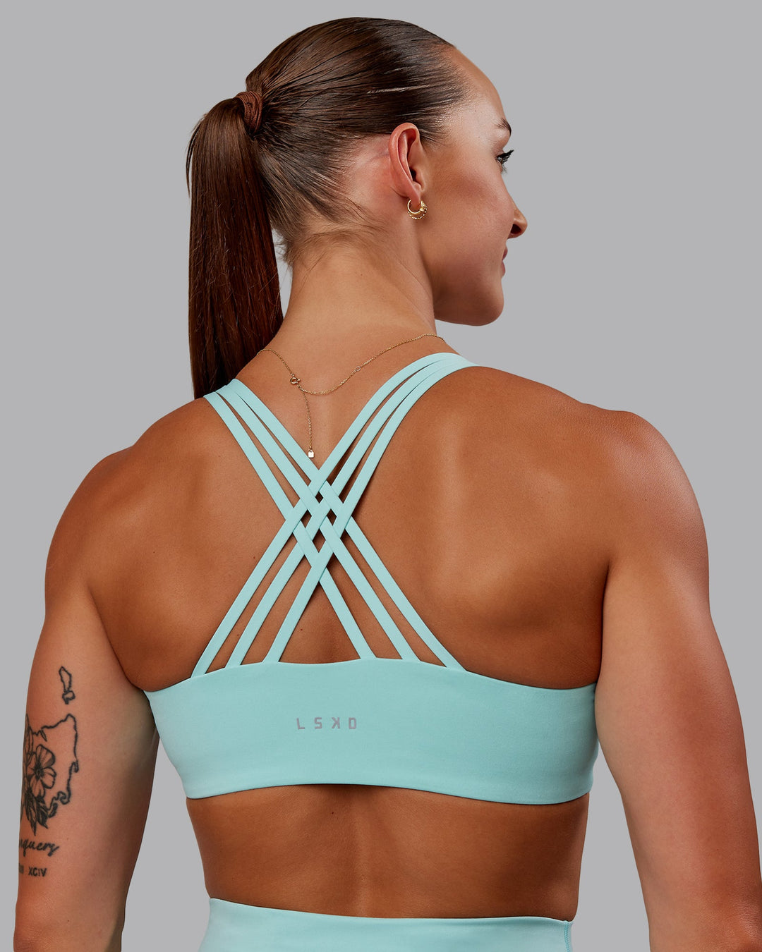 Woman wearing Push The Limit Sports Bra in Island Paradise | Size:S