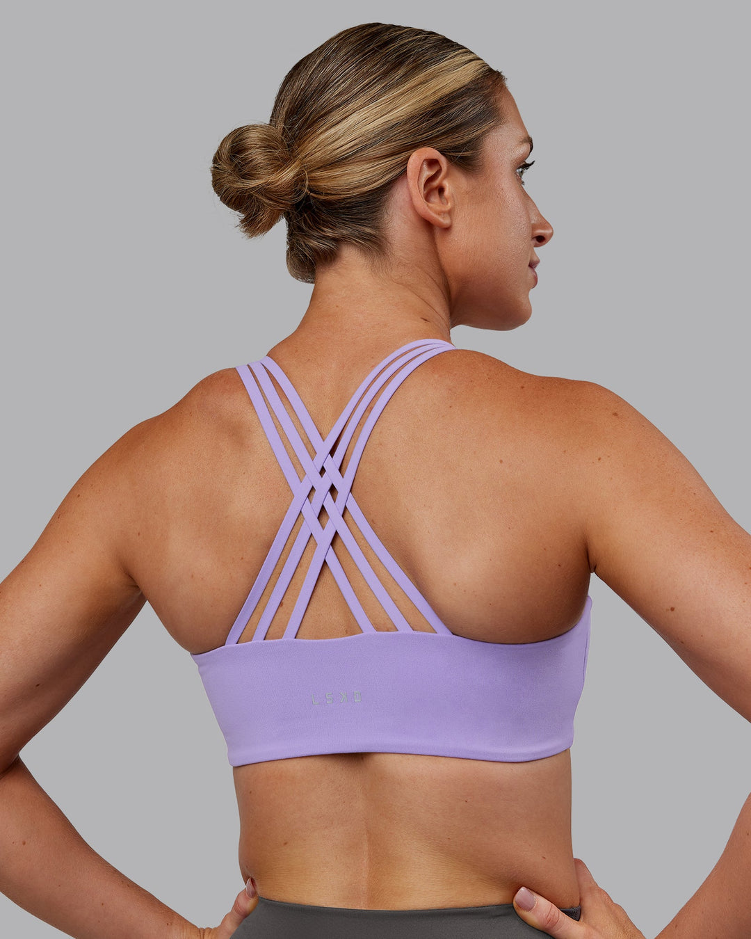 Woman wearing Push The Limit Sports Bra - Violet Ray | Model:Paris | Size:S