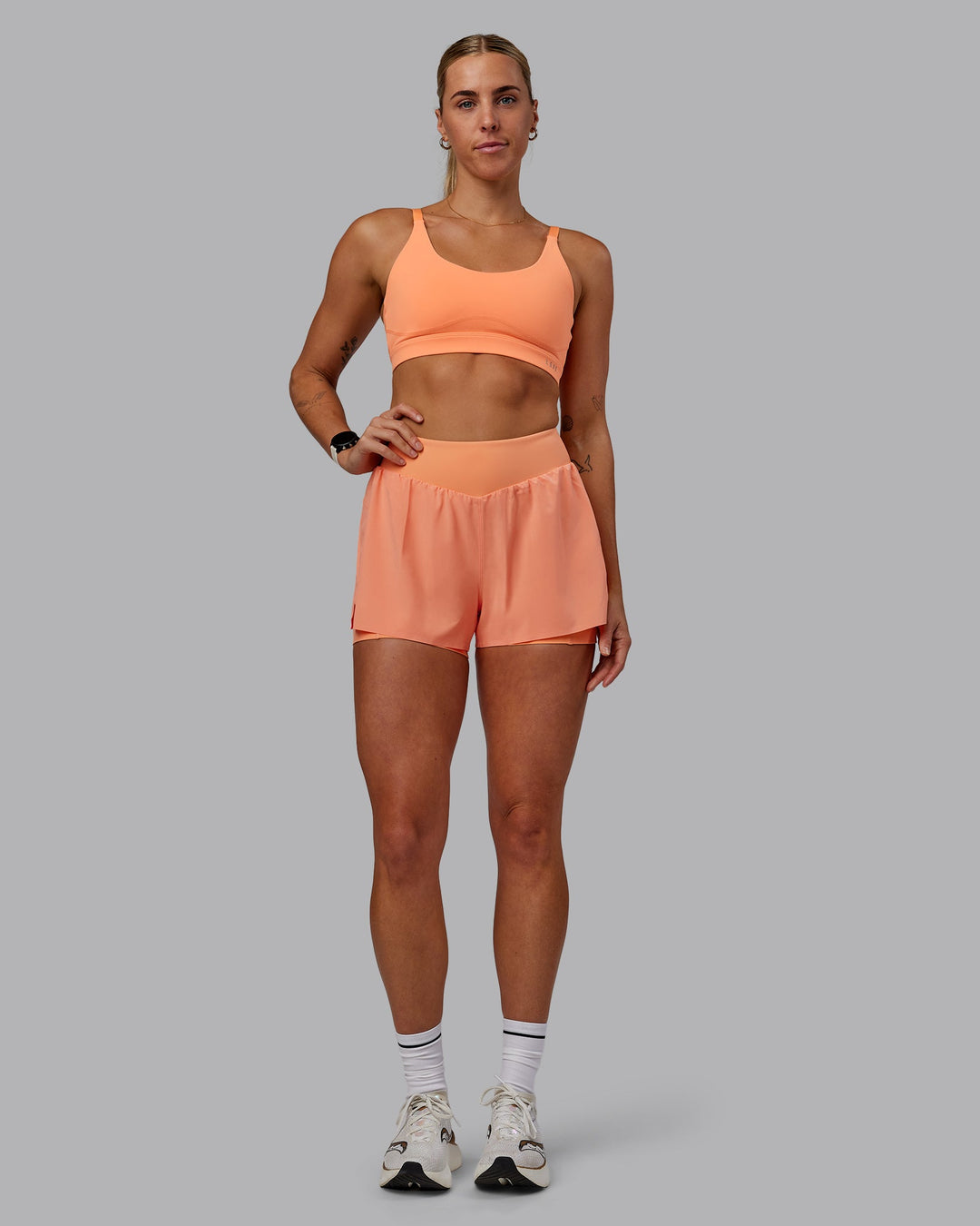 Woman wearing Rapid Sports Bra - Cantaloupe