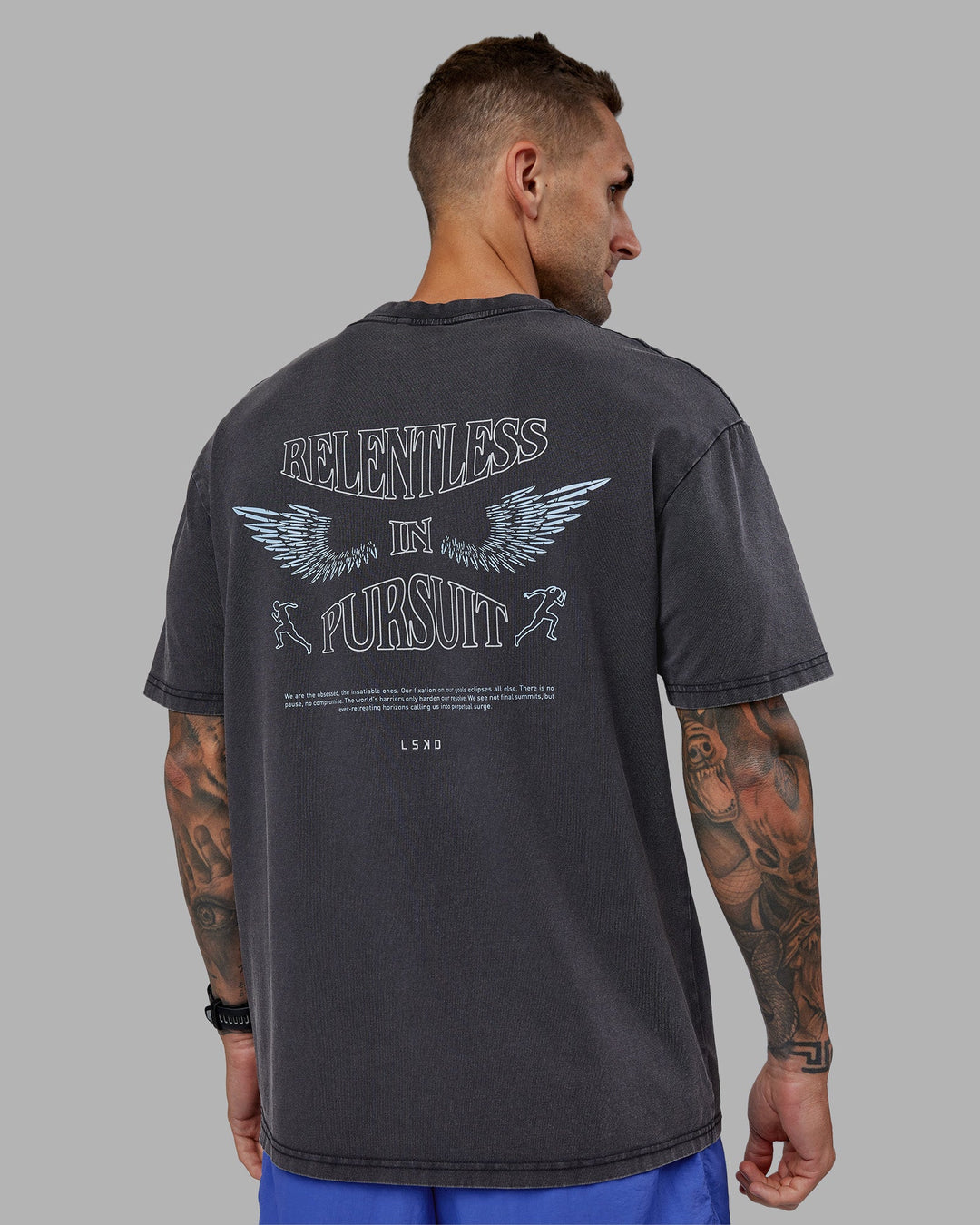 Man wearing Relentless Washed FLXCotton Oversized Tee - Black-Ultimate Grey | Model:Tommy | Size:S