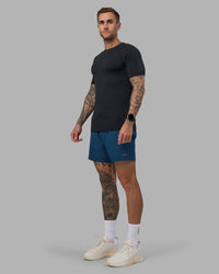Man wearing Rep 5" Performance Short - Night Sea | Model:Tommy | Size:S