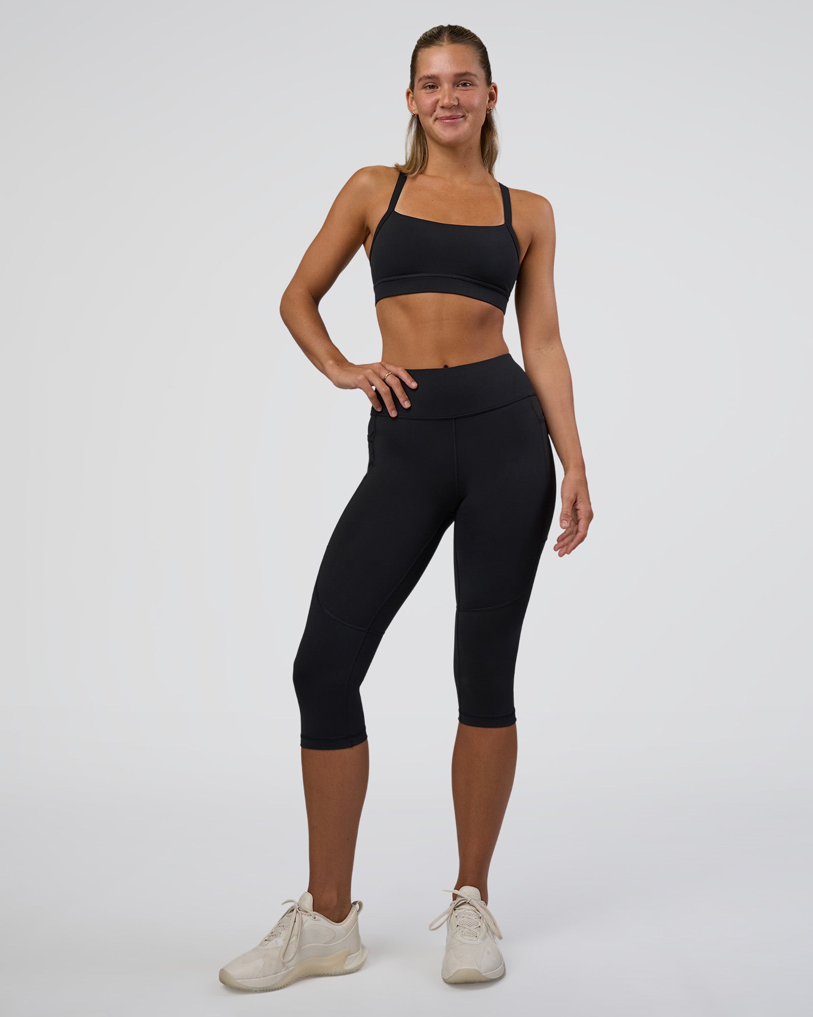 Woman wearing Rep Ultra High-Rise 3/4 Legging Pockets - Black-Black | Model:Amity | Size:S