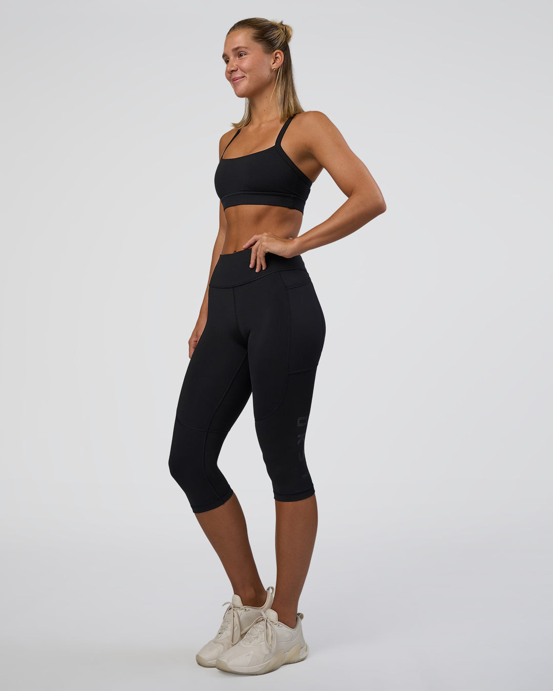 Woman wearing Rep Ultra High-Rise 3/4 Legging Pockets - Black-Black | Model:Amity | Size:S