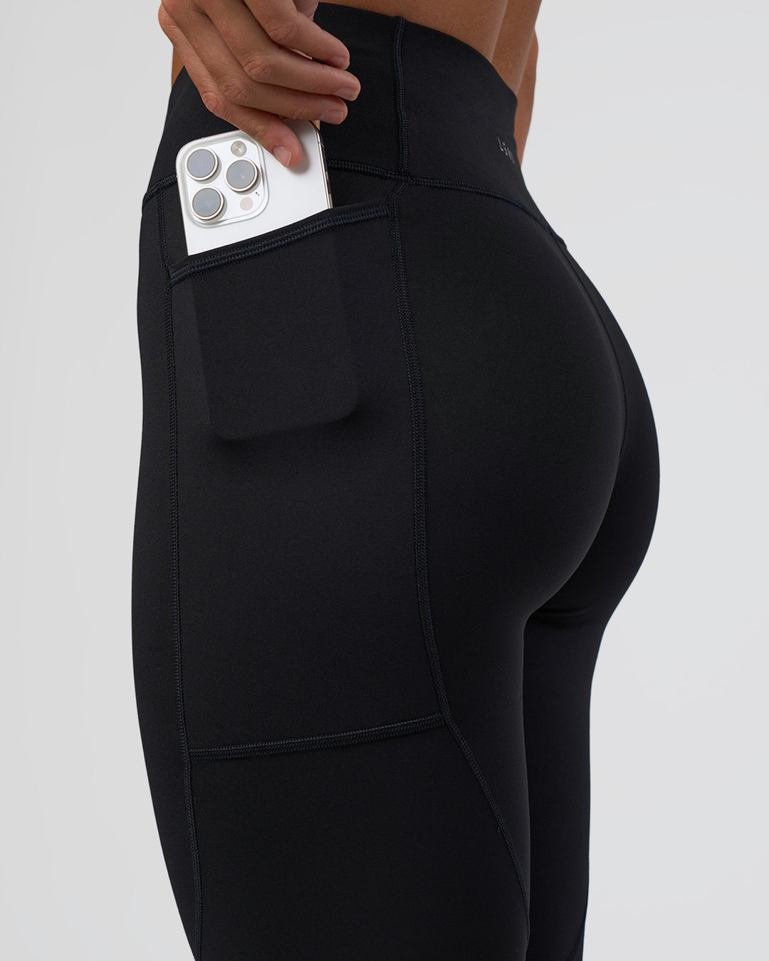 Woman wearing Rep Ultra High-Rise 3/4 Legging Pockets - Black-Black | Model:Amity | Size:S