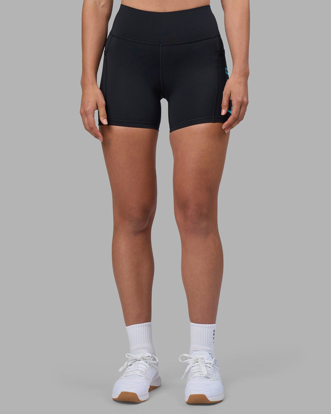 Woman wearing Rep Ultra High-Rise 4&quot; Short Pockets - Black-Blue Atoll | Model:Sophie | Size:S