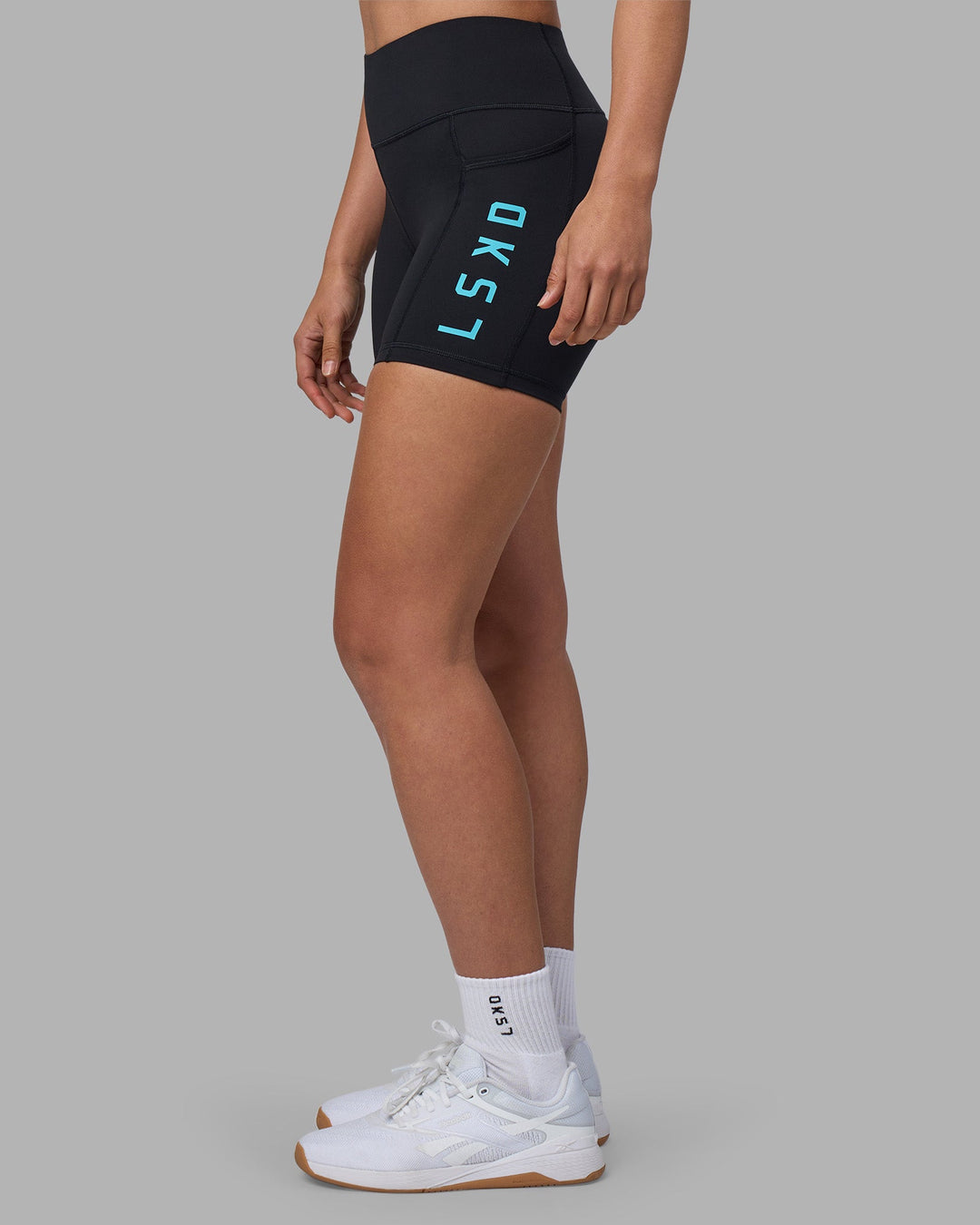 Woman wearing Rep Ultra High-Rise 4&quot; Short Pockets - Black-Blue Atoll | Model:Sophie | Size:S