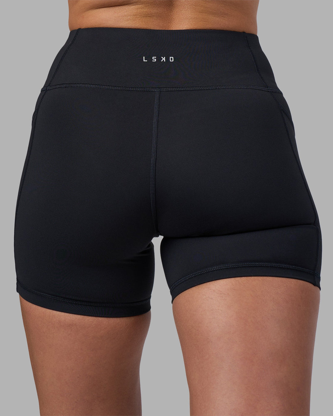 Woman wearing Rep Ultra High-Rise 4&quot; Short Pockets - Black-Blue Atoll | Model:Sophie | Size:S