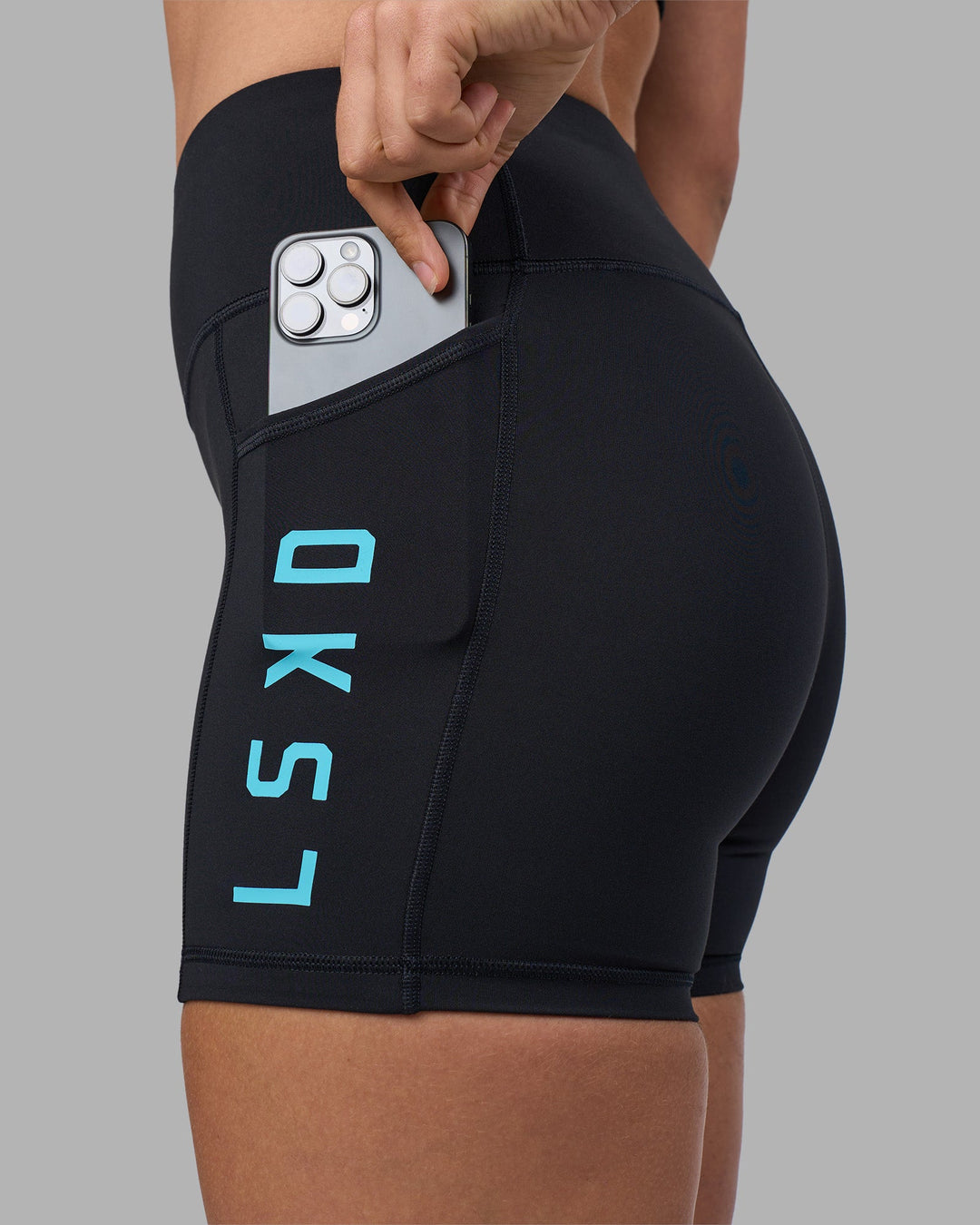 Woman wearing Rep Ultra High-Rise 4&quot; Short Pockets - Black-Blue Atoll | Model:Sophie | Size:S