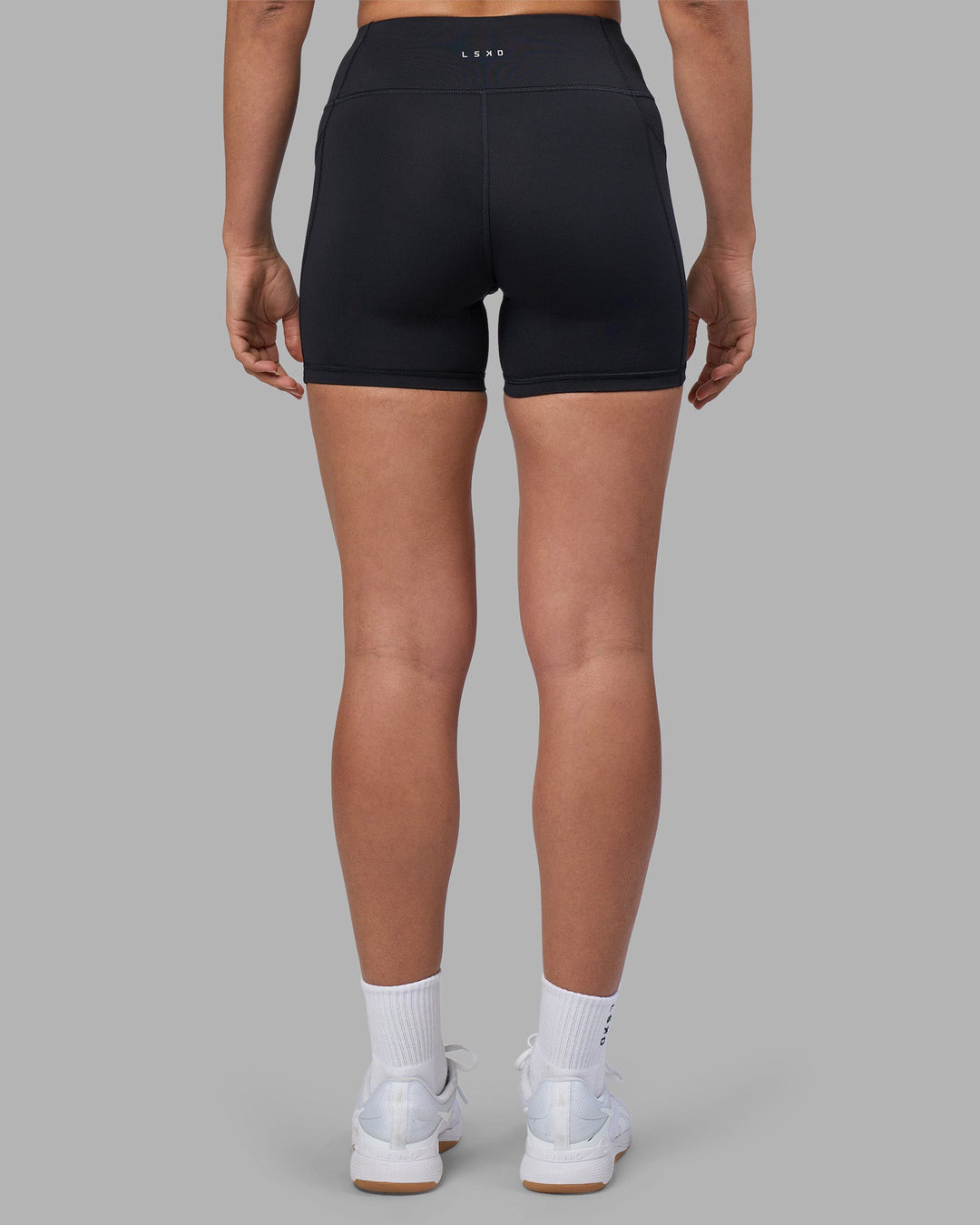 Woman wearing Rep Ultra High-Rise 4&quot; Short Pockets - Black-Blue Atoll | Model:Sophie | Size:S