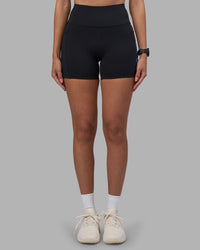 Woman wearing Rep Ultra High-Rise 4" Short Pockets - Black-Power Cobalt | Model:Rhiley | Size:S