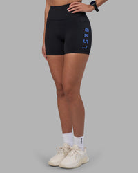Woman wearing Rep Ultra High-Rise 4" Short Pockets - Black-Power Cobalt | Model:Rhiley | Size:S