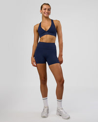 Woman wearing Rep Ultra High-Rise 4" Short Pockets - Future Navy-White | Model:Evie | Size:S