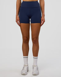 Woman wearing Rep Ultra High-Rise 4" Short Pockets - Future Navy-White | Model:Evie | Size:S