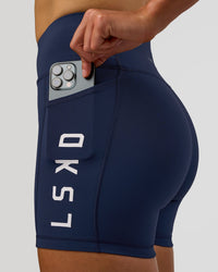 Woman wearing Rep Ultra High-Rise 4" Short Pockets - Future Navy-White | Model:Evie | Size:S