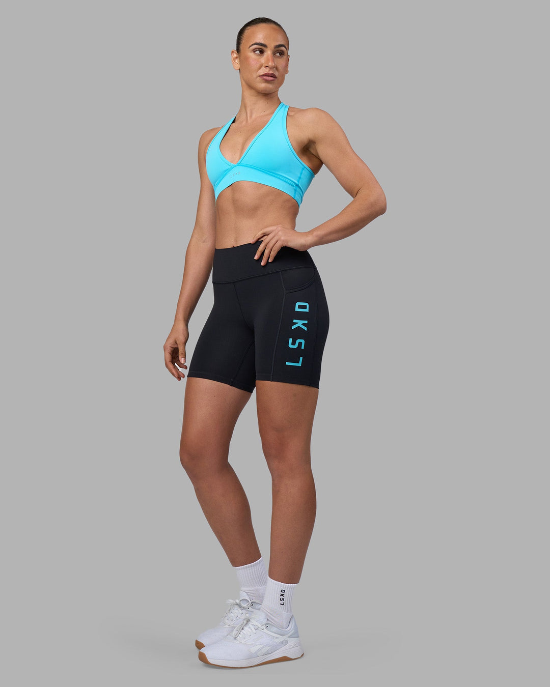 Woman wearing Rep Ultra High-Rise 6&quot; Short Pockets - Black-Blue Atoll | Model:Sophie | Size:S