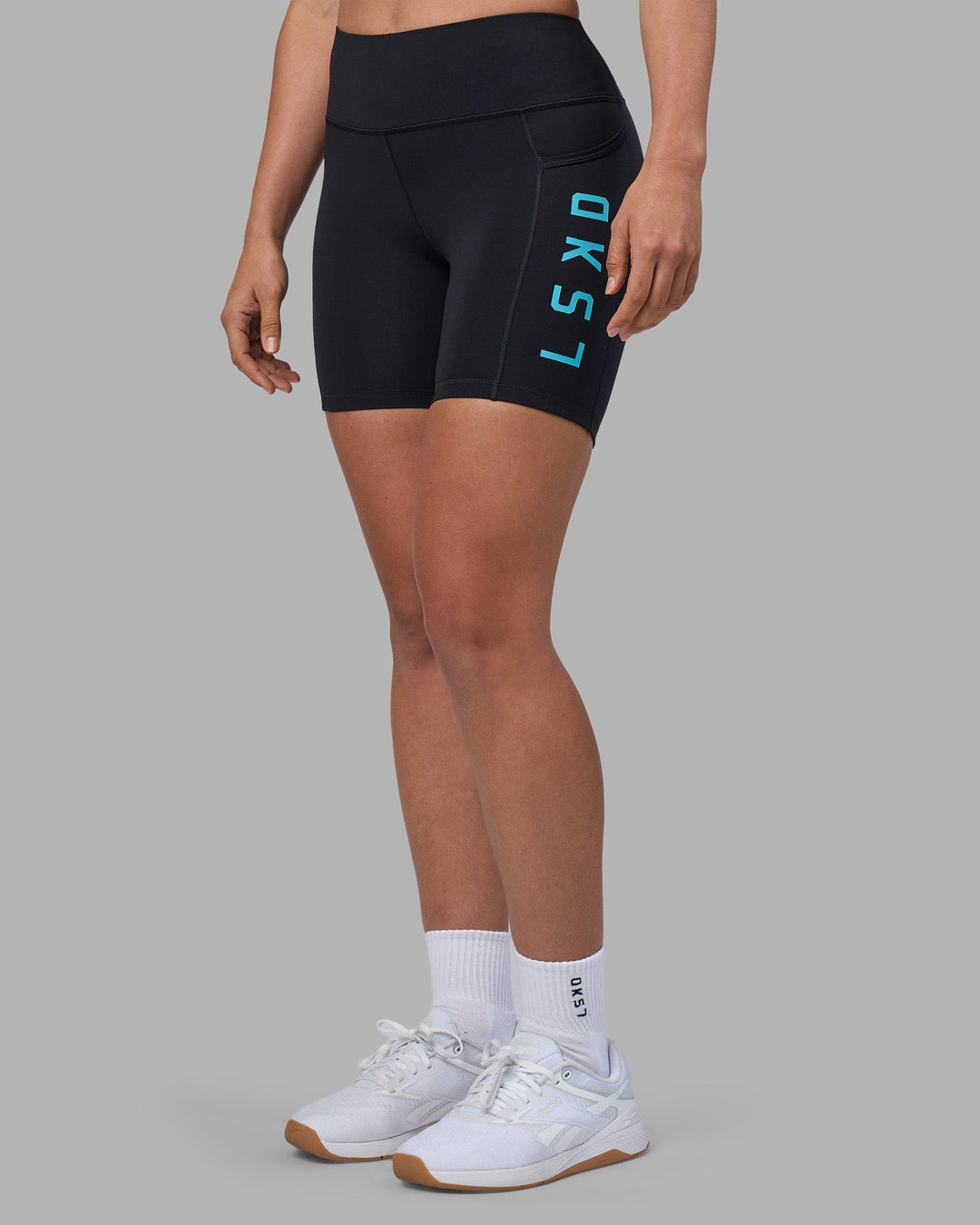 Woman wearing Rep Ultra High-Rise 6&quot; Short Pockets - Black-Blue Atoll | Model:Sophie | Size:S