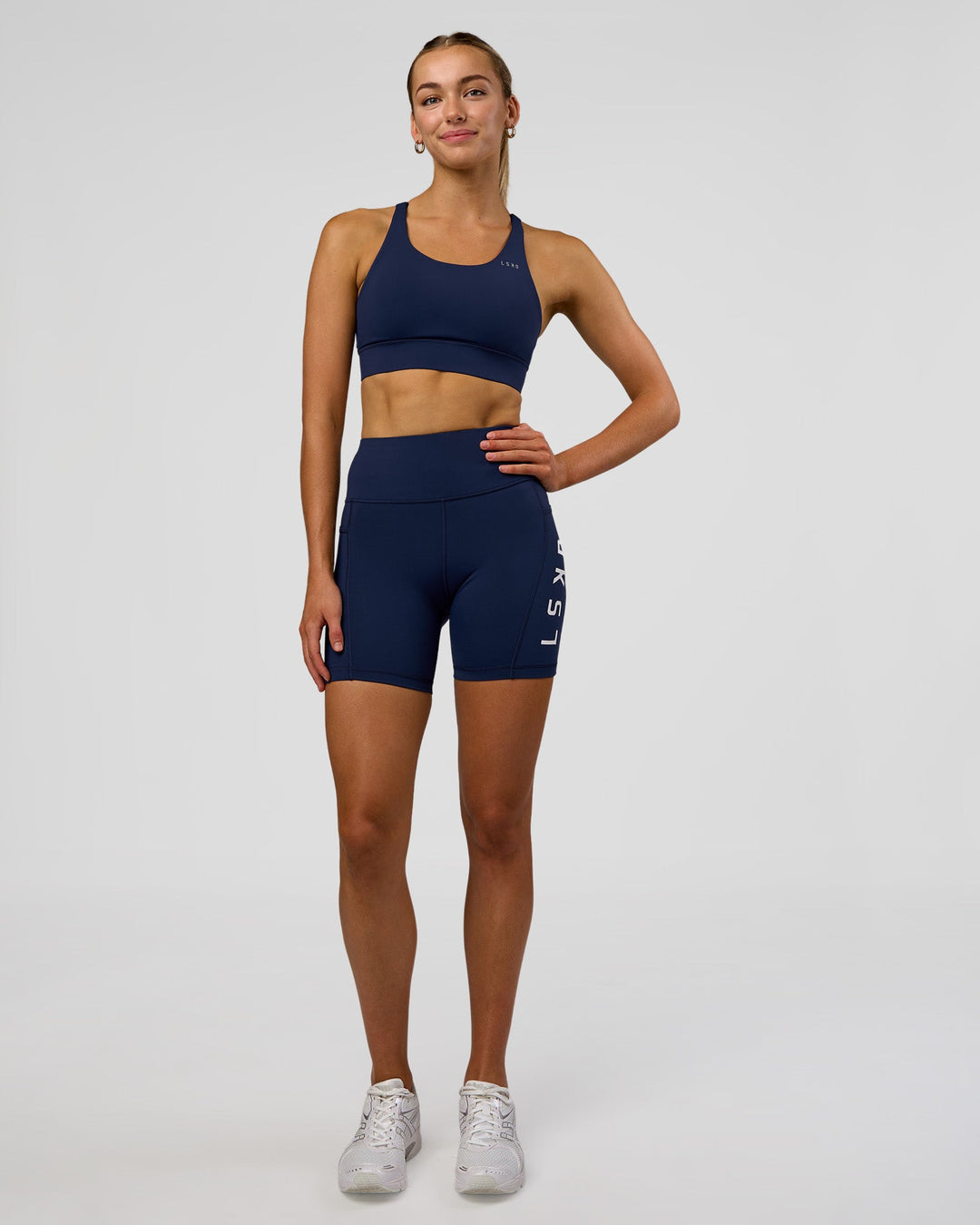 Woman wearing Rep Ultra High-Rise 6" Short Pockets - Future Navy-White | Model:Evie | Size:S
