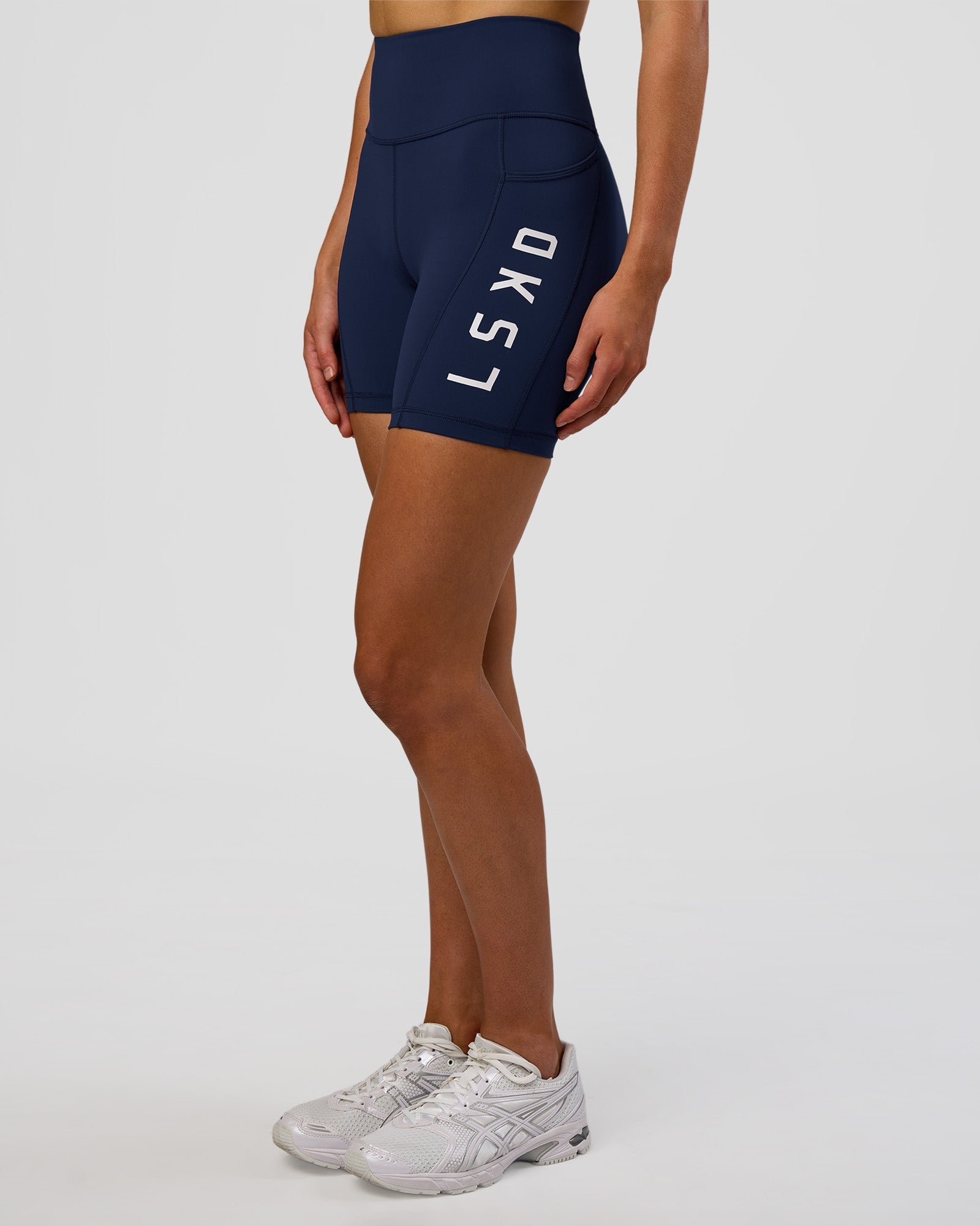 Woman wearing Rep Ultra High-Rise 6" Short Pockets - Future Navy-White | Model:Evie | Size:S