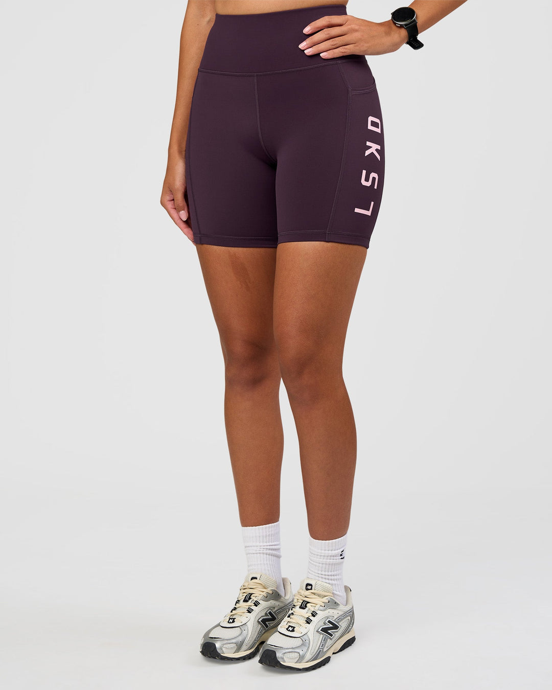 Woman wearing Rep Ultra High-Rise 6" Short Pockets - Midnight Plum-Marshmallow | Model:Rhiley | Size:S
