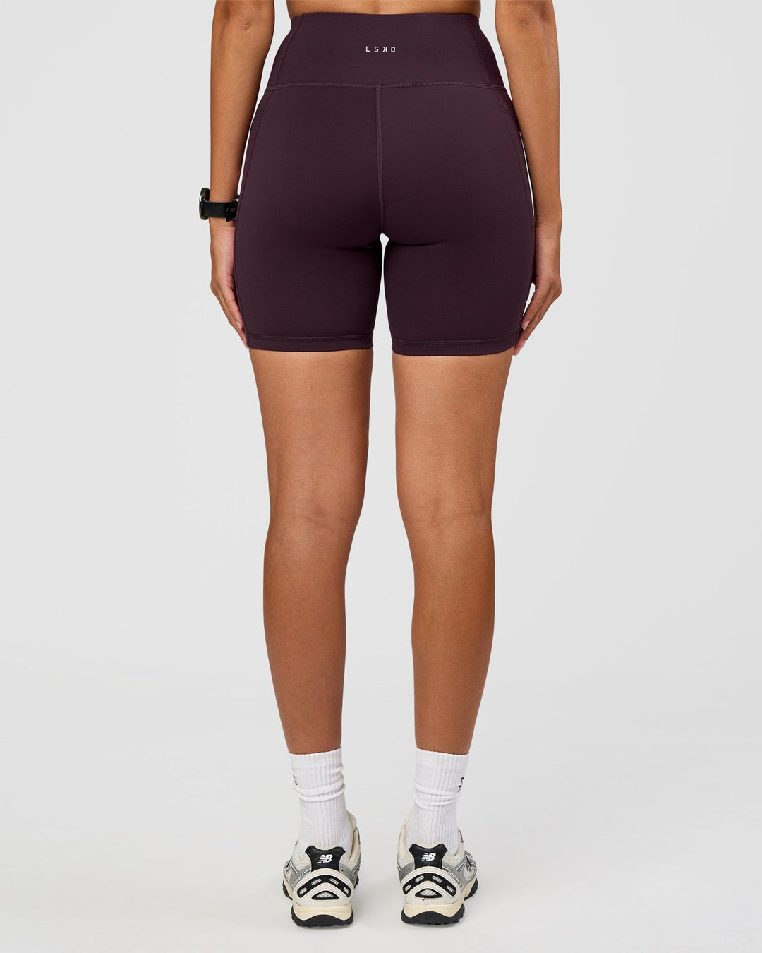 Woman wearing Rep Ultra High-Rise 6" Short Pockets - Midnight Plum-Marshmallow | Model:Rhiley | Size:S