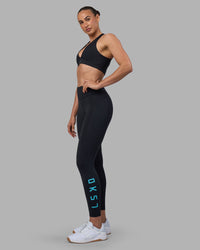 Woman wearing Rep Ultra High-Rise 7/8 Legging Pockets - Black-Blue Atoll | Model:Sophie | Size:S | Thumbnail Index: 0
