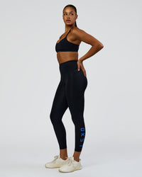Woman wearing Rep Ultra High-Rise 7/8 Legging Pockets - Black-Palace Blue | Model:Rosie | Size:S
