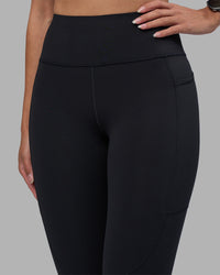 Woman wearing Rep Ultra High-Rise 7/8 Legging Pockets - Black-Power Cobalt | Model:Rhiley | Size:S