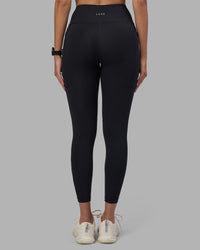 Woman wearing Rep Ultra High-Rise 7/8 Legging Pockets - Black-Power Cobalt | Model:Rhiley | Size:S