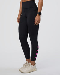 Woman wearing Rep Ultra High-Rise 7/8 Legging Pockets - Black-Ultra Fuchsia | Model:Abbey | Size:S