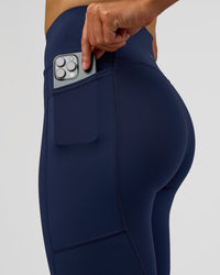 Woman wearing Rep Ultra High-Rise 7/8 Legging Pockets - Future Navy-White | Model:Evie | Size:S