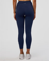 Woman wearing Rep Ultra High-Rise 7/8 Legging Pockets - Future Navy-White | Model:Evie | Size:S